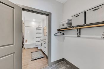 a bedroom with a medium sized bed and a mirror on the wall